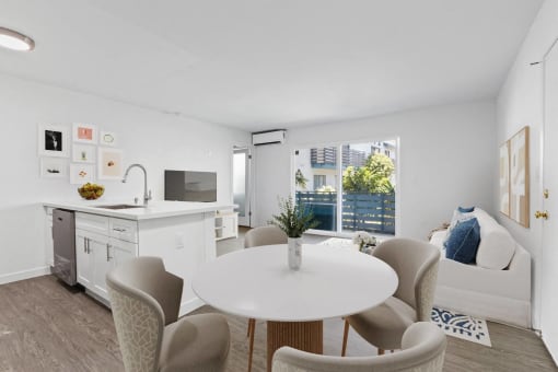 a living room with a white table and chairs