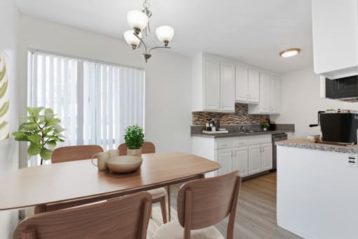 a kitchen and dining room with a table and chairs
