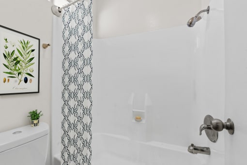 a bathroom with a shower and a toilet and a shower curtain
