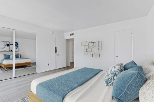 a bedroom with a large bed and a mirror