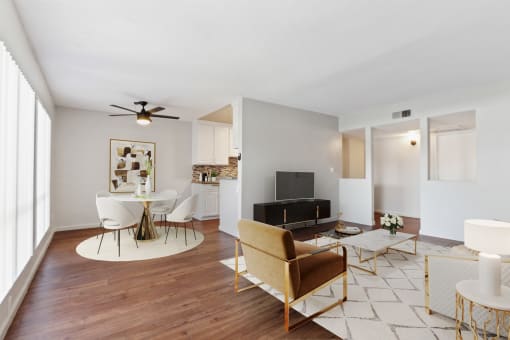 a living room with furniture and a ceiling fan