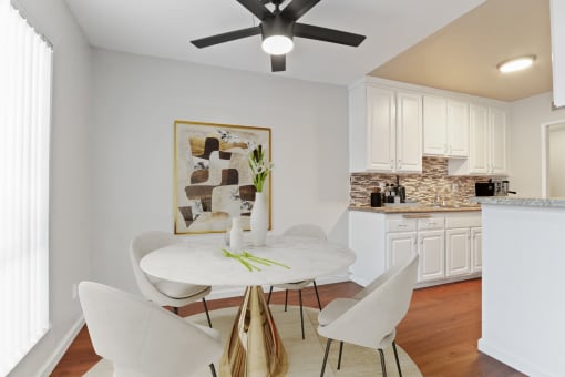 a dining room with a white table and chairs