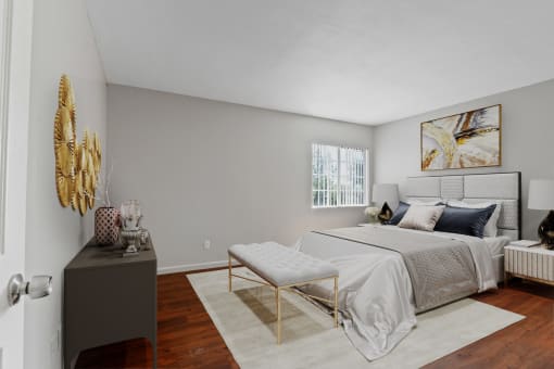 a bedroom with a bed and a dresser and a window