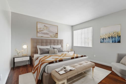 a bedroom with a bed and a couch and a window