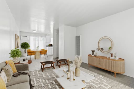 a living room with a couch and a table and a mirror
