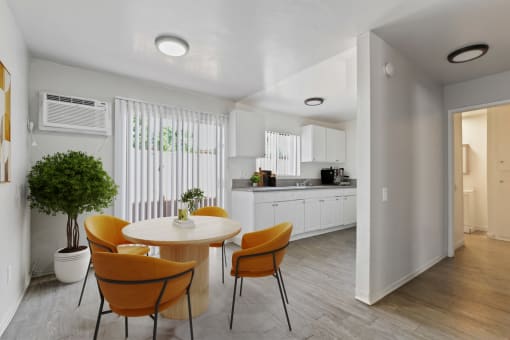 an open kitchen and dining room with a table and chairs