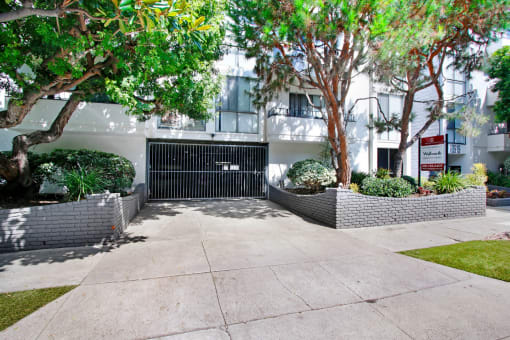 a gated driveway in front of an apartment building
