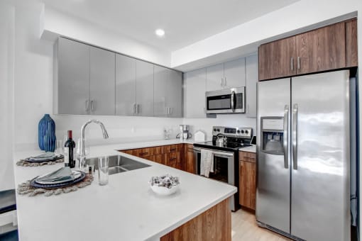 a kitchen with stainless steel appliances and a white counter top