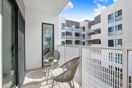 a balcony with two chairs and a table