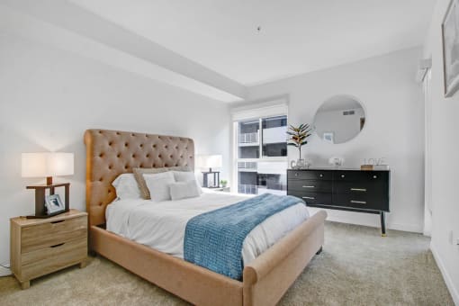 a bedroom with a bed and a dresser and a window