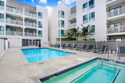 a swimming pool in front of an apartment building