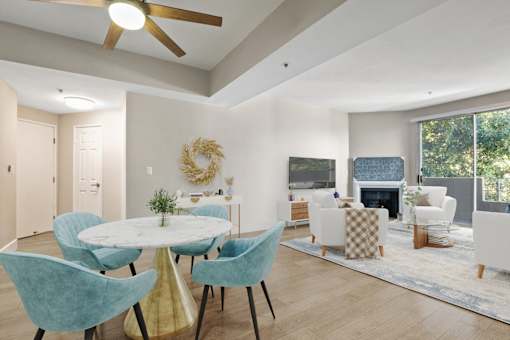 A dining room with a round table and chairs.