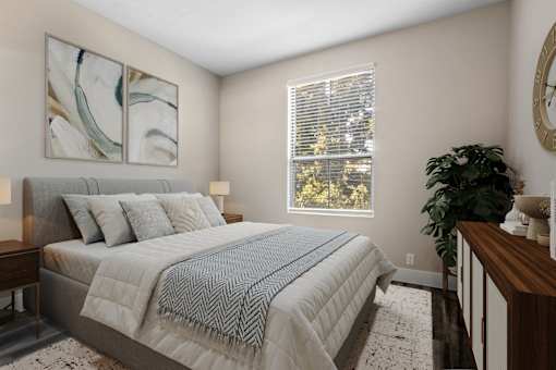 A bedroom with a large bed and a painting on the wall.