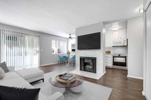 a living room with a couch and a table and a fireplace