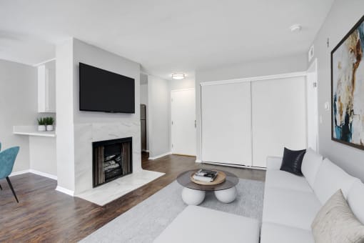 a living room with a white couch and a fireplace