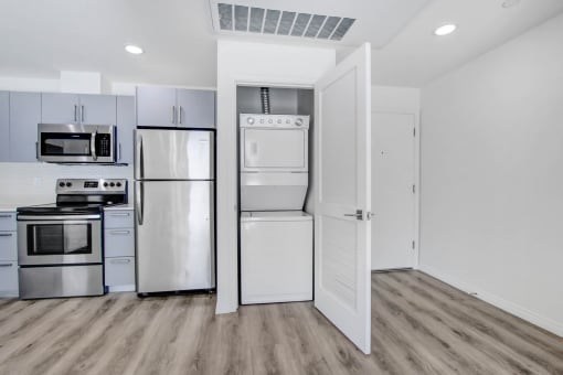 a kitchen with stainless steel appliances and white cabinets