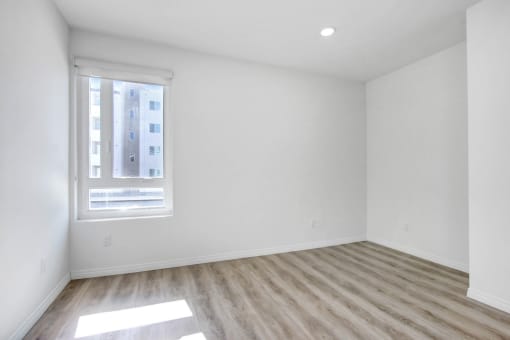 an empty room with white walls and a window