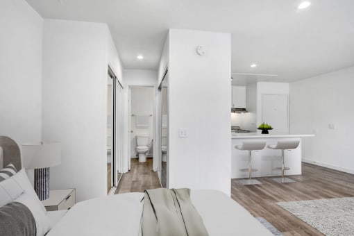 a bedroom with a bed and a desk and a bathroom