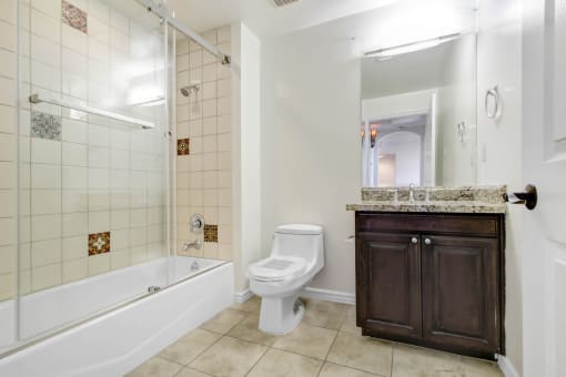 a bathroom with a toilet and a tub and a sink