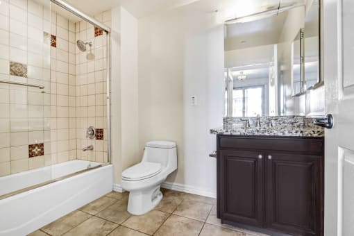 a bathroom with a toilet and a shower and a sink