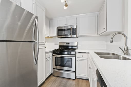 a kitchen with stainless steel appliances and white cabinets