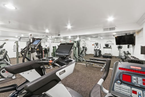 a gym with treadmills and other exercise equipment