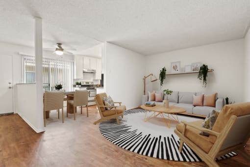 the living room and dining room of an apartment
