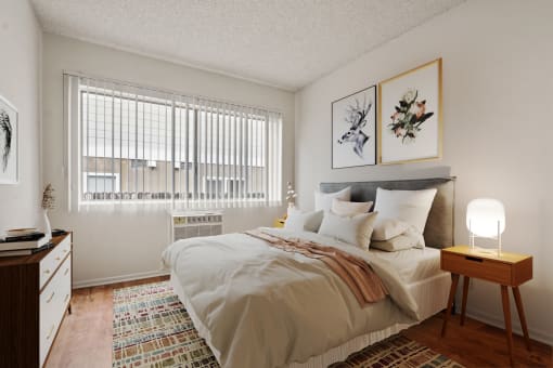 a bedroom with a large bed and a window