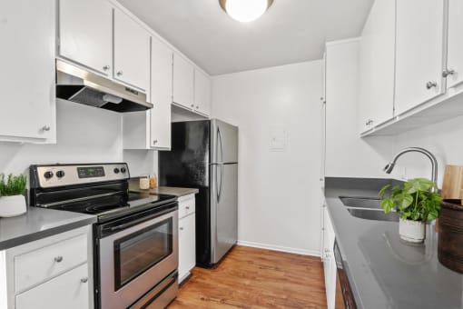 a kitchen with white cabinets and stainless steel appliances