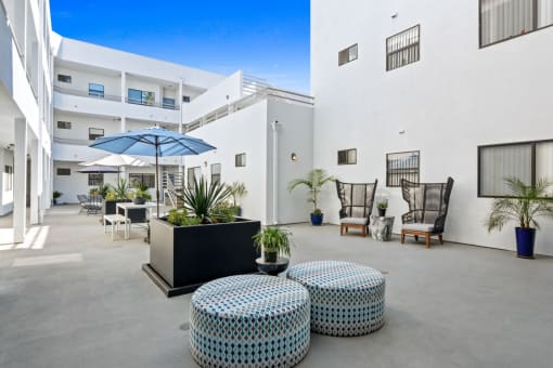 a patio with tables and chairs and umbrellas
