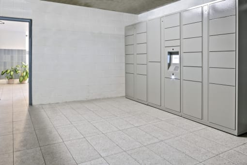 a row of white lockers in a room with a tiled floor