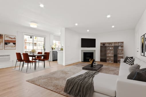 a living room with a white couch and a table with chairs