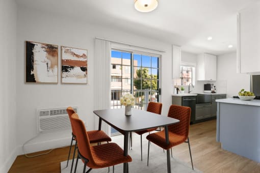 a dining room with a table and chairs and a kitchen