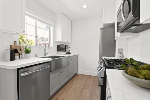a kitchen with stainless steel appliances and a large window
