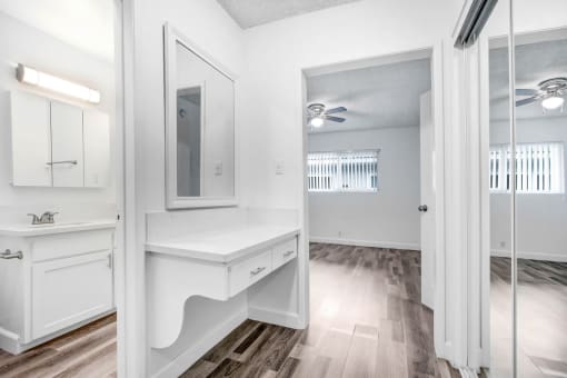 a white bathroom with a sink and a mirror