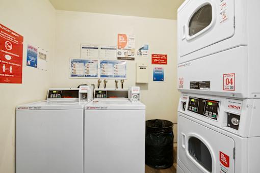 a laundry room with two washes and two washing machines