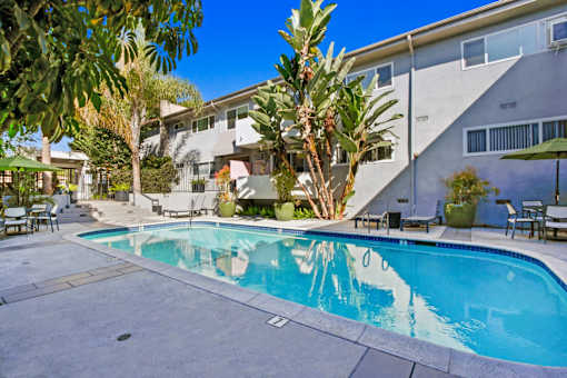 a swimming pool with a building in the background