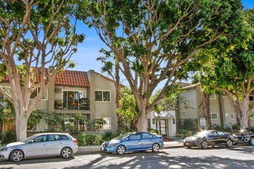the front of a house with cars parked in front of it