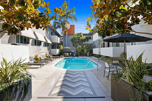 a swimming pool in the middle of a hotel courtyard