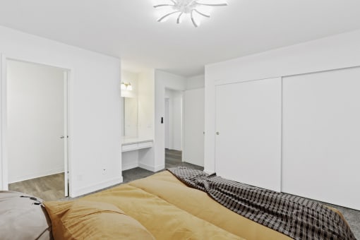 a bedroom with white closets and a large bed