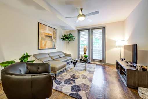 A living room with a brown leather chair and a white couch.