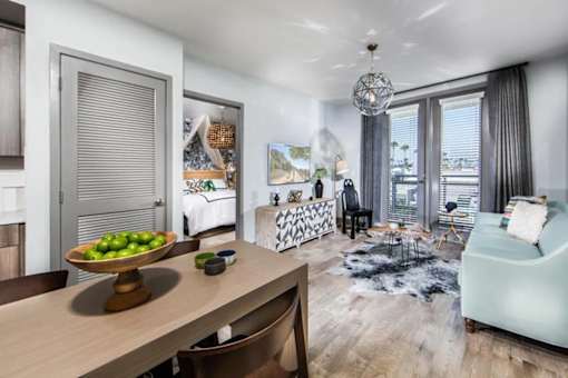 A modern living room with a dining table and chairs.
