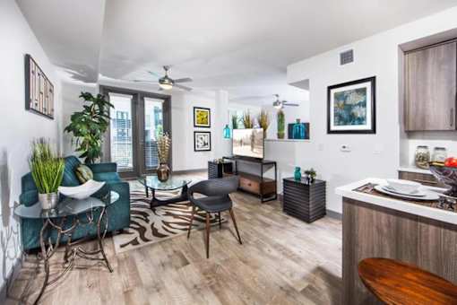 A living room with a blue couch and a zebra rug.