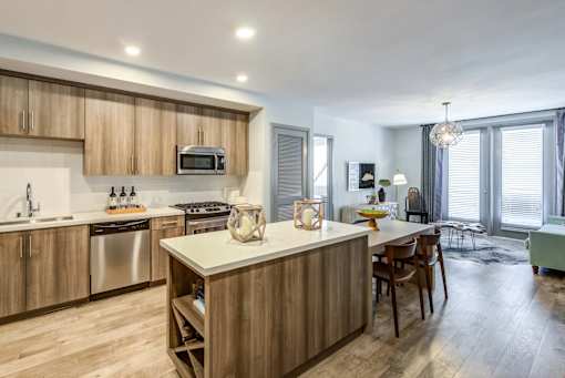 A modern kitchen with wooden cabinets and a central island.