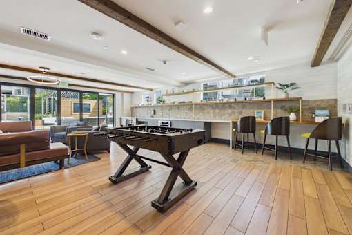 A kitchen with a black piano in the middle of the room.