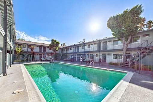 A sunny day at the pool in a residential area.