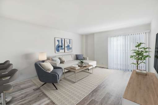 A living room with a grey chair and a white couch.