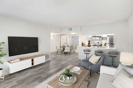 A modern living room with a flat screen TV, a grey sofa, and a wooden coffee table.