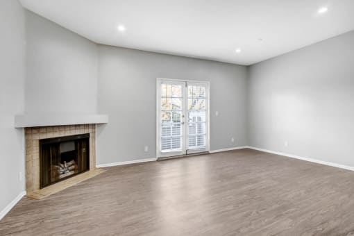 a living room with a fireplace and a door to a patio