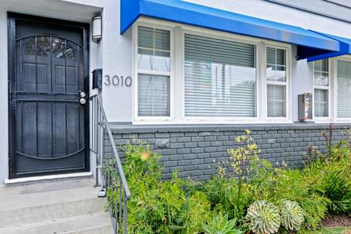the front of a house with a black door